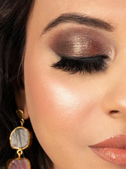 A close-up of this dark brown smoky eye with a pop of champagne shimmer on the lid. I used my own brand's lashes from The Eyebox to add drama and definition, creating a multi-dimensional look perfect for an evening event.