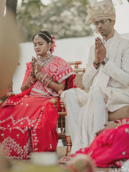 A moment of prayer and reverence during the wedding ceremony. The couple sits side-by-side, united in a solemn ritual, showcasing the spiritual foundation of their union.