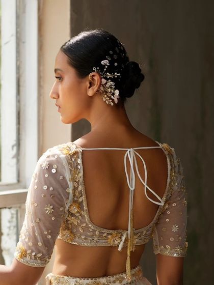 A beautiful shot of our floral earcuff styled in a bun, showcasing how it can be a stunning hair accessory as well.