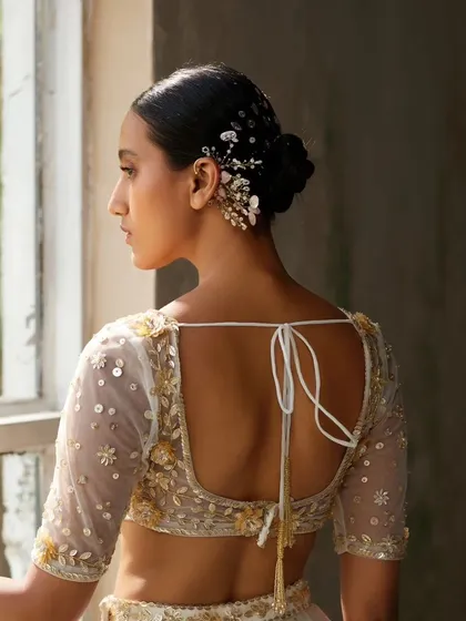A beautiful shot of our floral earcuff styled in a bun, showcasing how it can be a stunning hair accessory as well.