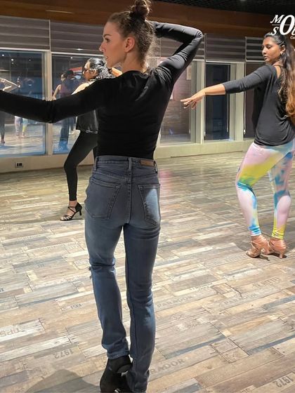 A student practices her arm styling and body movement during the workshop with our guest instructors.