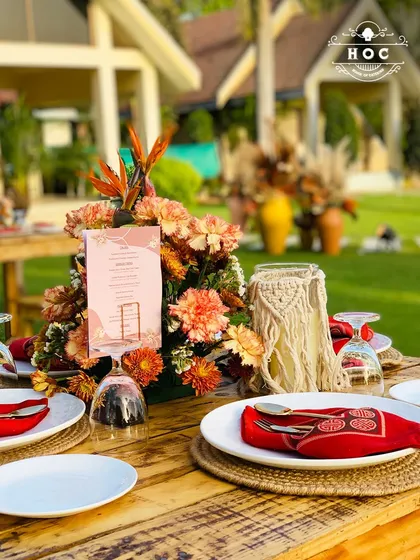 The dining table is the heart of any celebration. We design complete tablescapes that match your event's theme, from this rustic-boho setting with macrame details and natural wood to more formal, opulent arrangements.