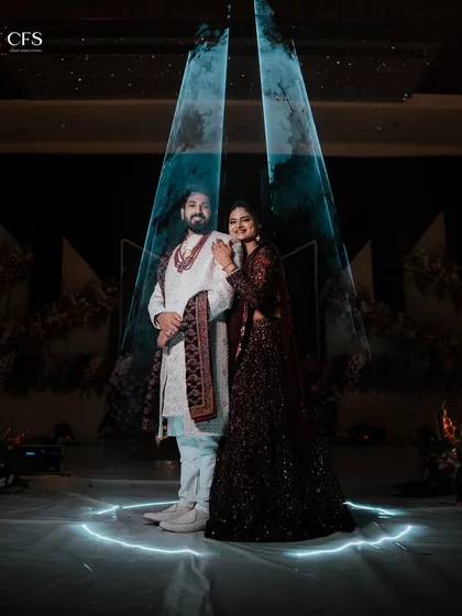 A modern and dramatic couple portrait using creative lighting to craft a unique, memorable image. This shot shows our ability to blend traditional attire with contemporary and artistic photography techniques for your engagement or reception.