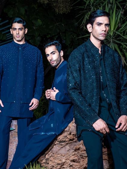 Our celebratory ensembles are showcased in this group shot, featuring a range of deep blue and black Indo-Western outfits. Each piece is crafted to enhance the wearer's style for any festive occasion.