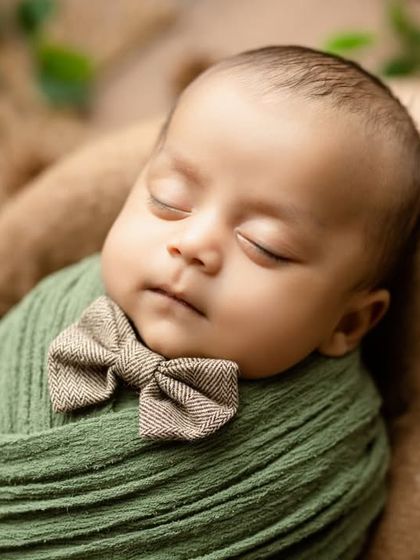 Our little gentleman, looking dapper with a tiny bowtie and a green swaddle.
