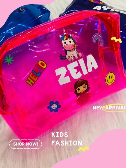 A close-up of our pink jelly pouch, customised with a name and adorable charms. It's a great way to keep smaller items organised in a larger bag.