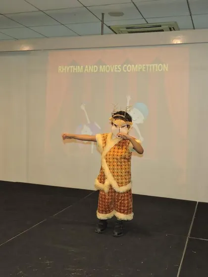 A student performs in a traditional costume, showcasing grace and focus. We celebrate diverse forms of expression and encourage children to connect with their cultural roots through performance.