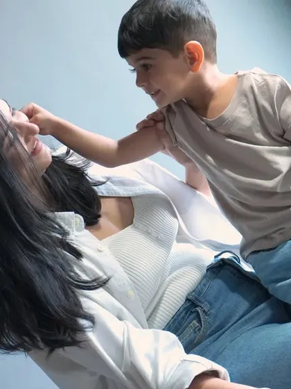 A candid, heartwarming moment between a mother and her son, showcasing a natural and playful interaction. This is an example of our "mom & me" family bonding photo sessions.