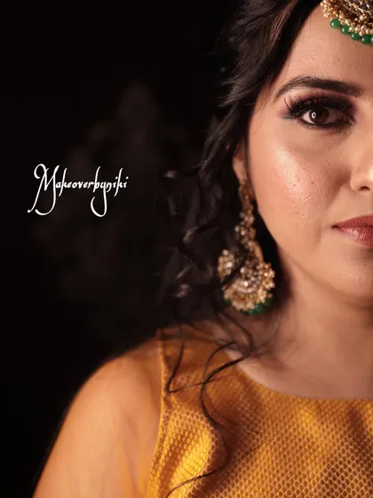 An artistic half-face portrait showing the detail of the eye makeup for Chinmayi's mehendi ceremony.