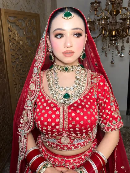 The side profile showcases the maang tikka and the heavy earrings, completing the bridal set.