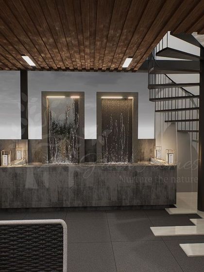 A key feature of our Ashok Vihar terrace project is this dual waterfall feature and a spiral staircase. This demonstrates our ability to incorporate custom hardscaping and multi-level access into our designs.