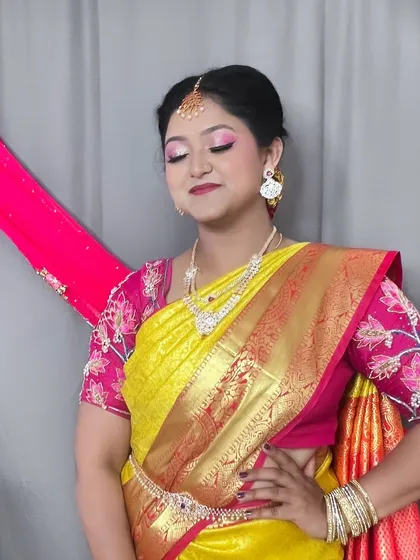 This pose shows off the beautiful saree and the way the makeup enhances her side profile, highlighting her cheekbones and jawline.
