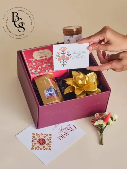 This image shows the unboxing of a chic Diwali gift. The focus on the personalized card and the elegant items inside highlights the thoughtful curation process.