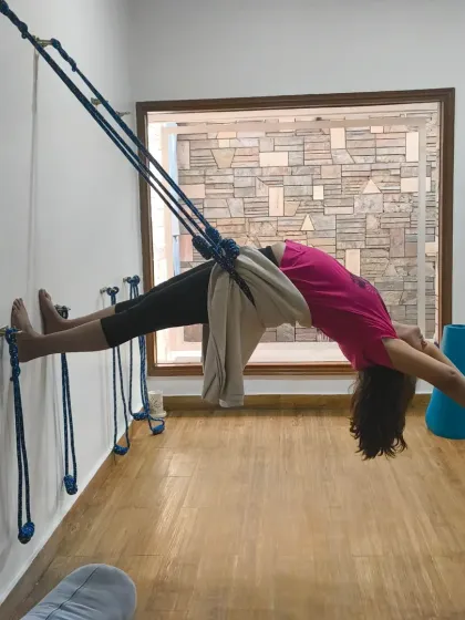 Let's choose to be grateful right now. A student in a beautiful backbend, suspended by the wall ropes, opening her heart with abundance.