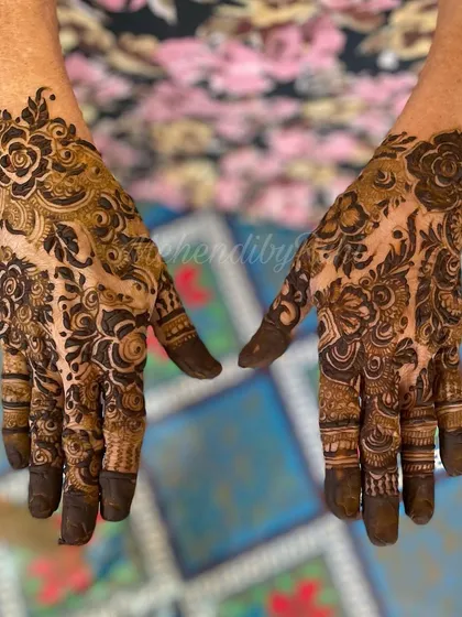 A beautiful collaboration with another artist. This design features dense floral work, with roses and leaves creating a lush, garden-like effect on the hands.