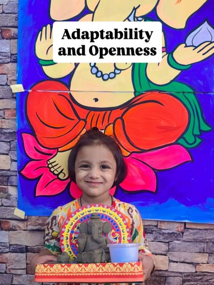 A young student holds her handmade Ganesha idol, representing the teaching of "Adaptability and Openness." We incorporate life lessons into our art.