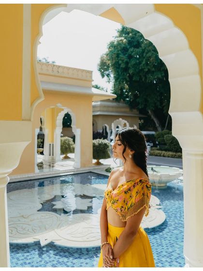 A peaceful moment of the bride with her eyes closed, framed by a palace archway. The soft light and serene expression make for a beautiful, contemplative portrait.