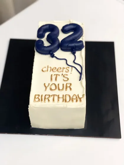 A similar minimalist loaf cake, this time for a 32nd birthday. The simple design puts the focus on the delicious cake inside.