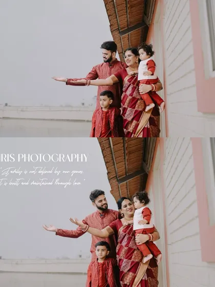 A lovely family portrait of parents with their two young children, all dressed in coordinating red traditional outfits. This photo captures a candid, happy moment during a family photoshoot.