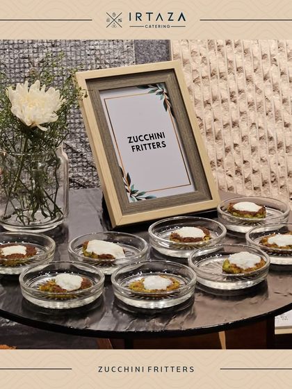 Zucchini Fritters are a light and savory option. These small, pan-fried fritters are served with a dollop of cream, offering a delightful texture and taste.