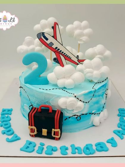 Flying high for a 2nd birthday! This cute airplane-themed cake features a plane soaring through fluffy marshmallow clouds.