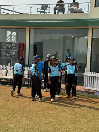 A coach talking to the players as they come off the field. We provide constant feedback to help our teams improve with every game.