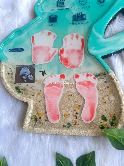 This section of the motherhood silhouette frame shows the baby's first handprints and footprints, along with the precious ultrasound picture. Every element tells a part of their story.