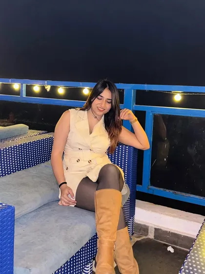 A relaxed, seated pose in the cafe. This shows me enjoying the atmosphere and makes the content feel natural.