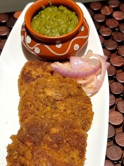 These are my special Yam Kebabs, served with fresh mint chutney and onion rings. They are crispy on the outside and wonderfully soft inside, made with a blend of spices that I've perfected over the years.