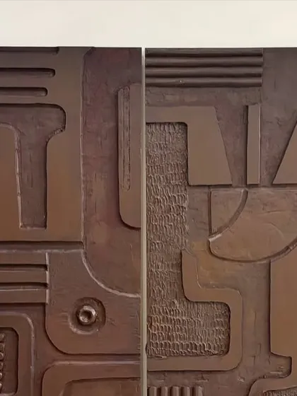 A detailed view of the carved wooden panels for the Jaipur project. The metallic bronze finish highlights the intricate, abstract geometric patterns.