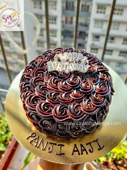 That rich double chocolate shine is something I'm very proud of. This cake, made for a 'Panji Aaji' (great-grandmother), features beautiful rosettes of dark chocolate ganache.