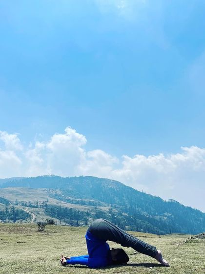 Halasana, or Plough Pose, against the backdrop of the mountains. The yoga mat is a mirror, and practicing in nature provides a beautiful reflection of our inner landscape.