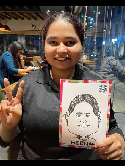A happy Starbucks employee with her caricature. We often do events at cafes, adding a fun, artistic touch to the customer experience.