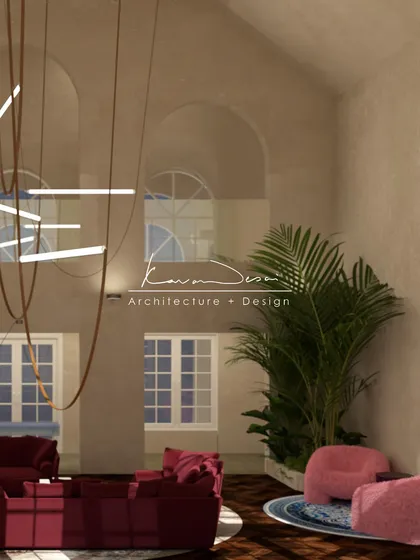 This view shows the double-height living space with its statement red sofa and custom hanging light fixture. The large arched windows flood the room with natural light, enhancing the feeling of openness.