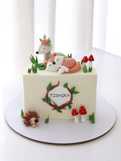 The full view of the sweet woodland-themed half birthday cake.
