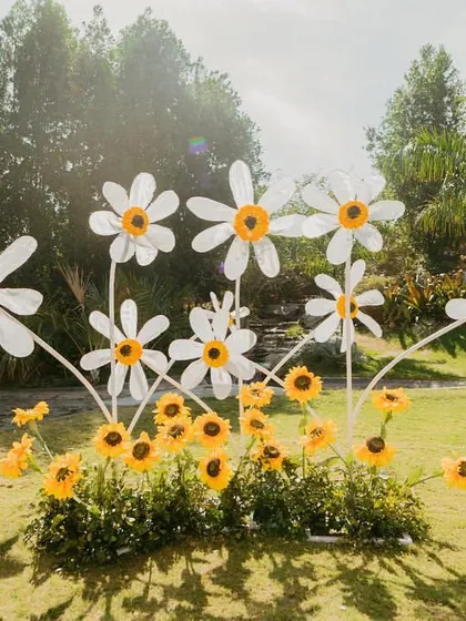 Giant daisies and sunflowers create a whimsical and happy installation for a 'Haldi Holi' party.