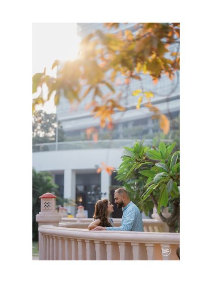 A lovely portrait of a couple framed by autumn leaves and soft sunlight. This creative composition adds a touch of artistry and warmth to their Haldi ceremony photos.