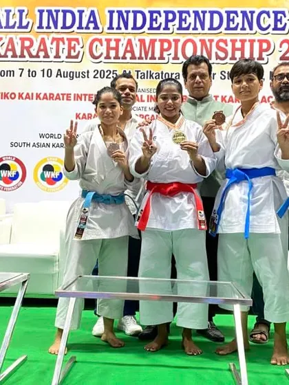 Celebrating with another group of medalists at the Independence Cup. Their victory signs show the joy and pride of competing at a top national event.
