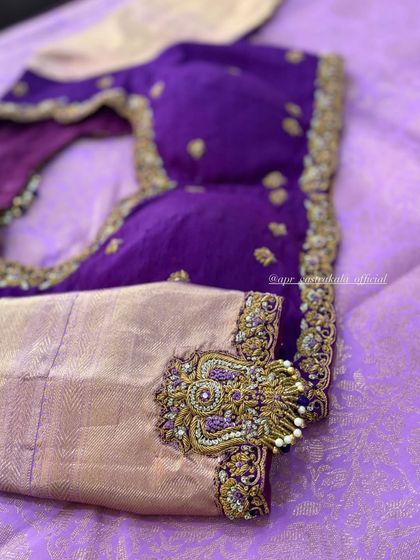 A purple blouse with a statement motif on the sleeve.