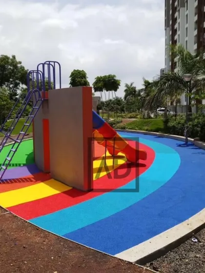 Safety is the top priority for children's play areas. This installation uses interlocking, shock-absorbent rubber flooring in bright, engaging colors. The surface is soft to cushion falls and durable enough to withstand constant use and all weather conditions.