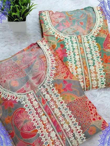 A beautiful set of two dress materials with digital prints and delicate lacework on the neckline. The soft colors and floral patterns make them ideal for daytime events.