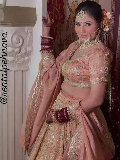 A side view of the peach-pink lehenga, highlighting the nose ring and hairstyle.