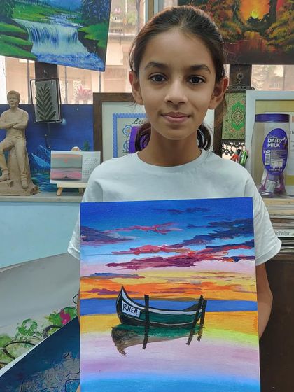 The colours of a sunset are magical. This artist captured a beautiful evening sky reflecting on the water in her serene boat painting.