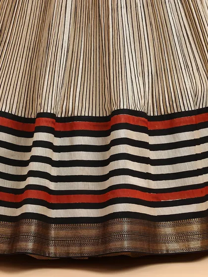 A detailed shot of the striped silk skirt, highlighting the texture of the fabric and the bold border design.