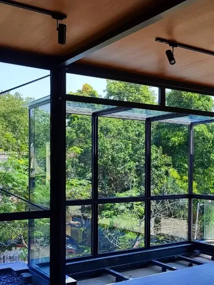 This lightweight, insulated glass cube in Golflinks, New Delhi, acts as a structural and experiential link between the home's interior and the lush greenery outside, dissolving the boundary between inside and out.