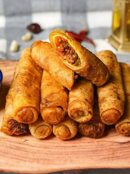Our Iftar Box includes delicious creations like these crispy kheema (minced meat) rolls, served with a fresh mint chutney for the perfect combination of flavours.