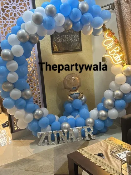 A "Welcome Home" decoration for a new baby boy. The blue and white balloon ring with a baby foil balloon is a perfect way to celebrate the new arrival.