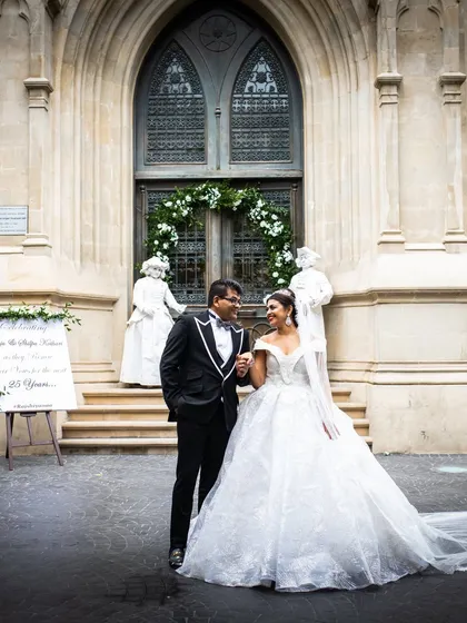 A timeless portrait of a couple after their church ceremony, with the bride in a stunning white ballgown.