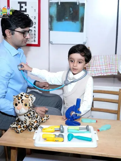 A father and son playing doctor in our pretend-play clinic. It's a wonderful way for parents to bond with their kids.