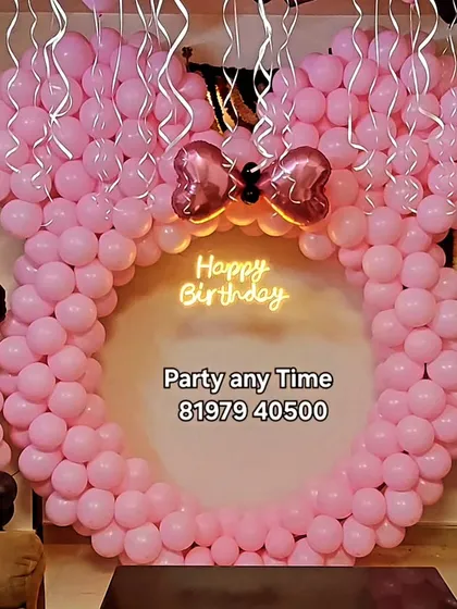 I can create large, impressive balloon sculptures for any theme. This giant Minnie Mouse head made of pink and black balloons makes a fantastic photo backdrop for a first birthday or any Disney-themed party.